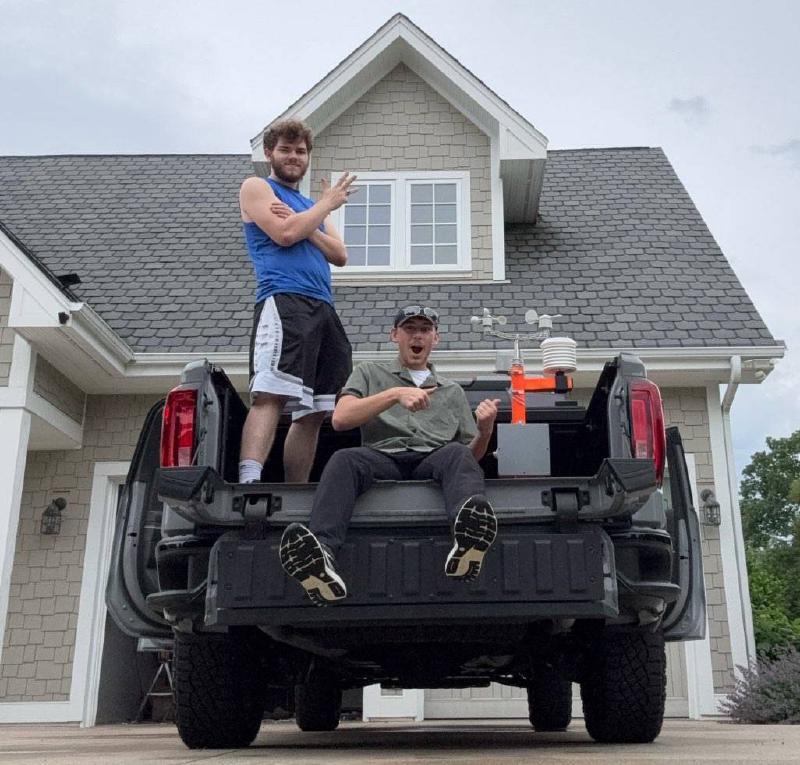 Eli Mares and Mason Edwards on their vehicle